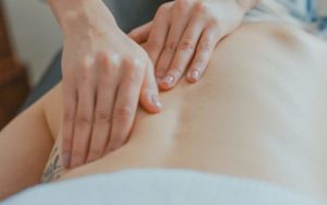 man massaging woman's body